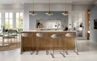 Blue and oak kitchen with brass handles and statement lighting – Cityscape range by Herts Kitchens