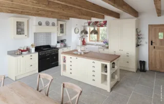 Cream country kitchen with wooden beams and central island