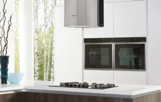 Modern kitchen with double built-in ovens and gloss white cabinets