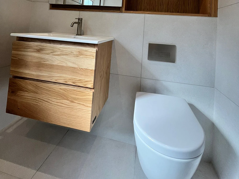 Minimalist bathroom design with floating wood vanity and wall-hung toilet