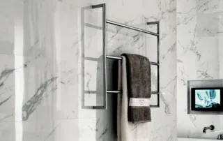 Luxurious marble-effect bathroom tiles with chrome towel rail
