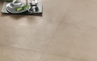 Close-up of natural sand-effect floor tiles in a neutral living space