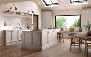 Light pebble-painted kitchen with marble splashback and skylight