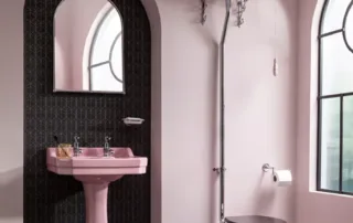 Vintage-style pink bathroom with high-level toilet cistern and pedestal basin