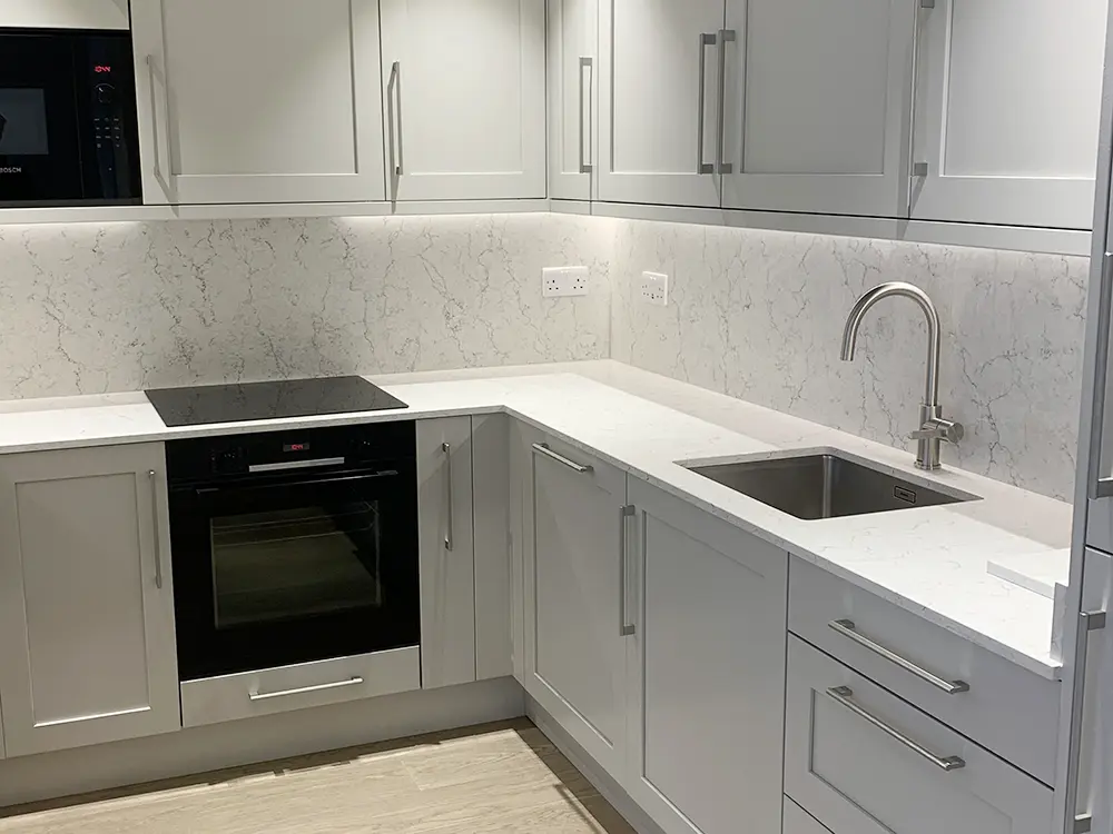 Contemporary Sheraton kitchen installed for a North West London apartment with painted limestone doors and Algarve worktops